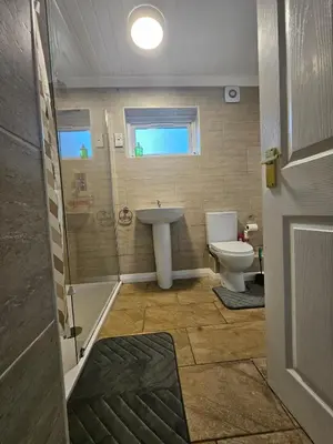 a bathroom with a sink and a toilet at Egremont 2-Bed Flat Near Lake District with Free Parking & Wi-Fi in Egremont