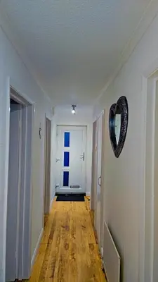 a hallway with a heart shaped mirror on the wall at Egremont 2-Bed Flat Near Lake District with Free Parking & Wi-Fi in Egremont