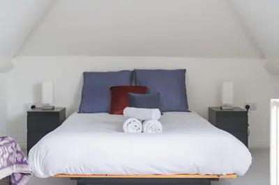 a bedroom with a bed with two towels on it at St Mary's House by Keepers Cottages in Moffat