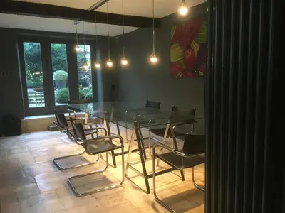 a dining room with a glass table and chairs at Gorgeous Georgian townhouse in Moffat