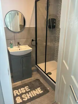 a bathroom with a shower and a sink and a mirror at Brig o Doon 3 in Ayr