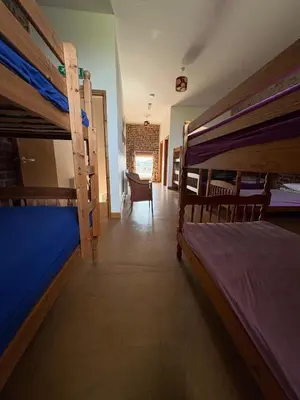 a room with three bunk beds and a chair at Hillside Farm in Carlisle
