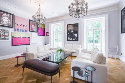 a living room with white furniture and a chandelier at The Victorian Residence in Moffat