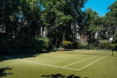 a tennis court with a net on top of it at The Victorian Residence in Moffat