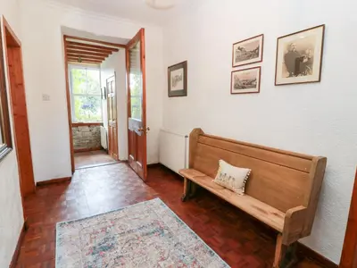a hallway with a wooden bench in a room at Balsaggart Farm in Maybole