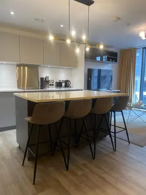 a kitchen with a large island in the middle of a room at The Bank Tower in Moffat