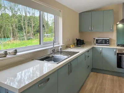 a kitchen with a sink and a window at Alderneuk Lodge - Uk49923 in Dumfries