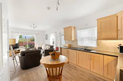 a kitchen and living room with a couch and a table at 8 Harney Peak in Portinscale