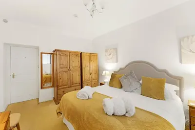 a bedroom with a large bed with towels on it at 8 Harney Peak in Portinscale