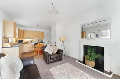 a living room with a couch and a fireplace at 8 Harney Peak in Portinscale