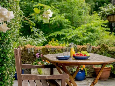 a wooden table with a bowl of fruit and a bottle at 4 Bed in Cockermouth oc-sz098 in Lorton