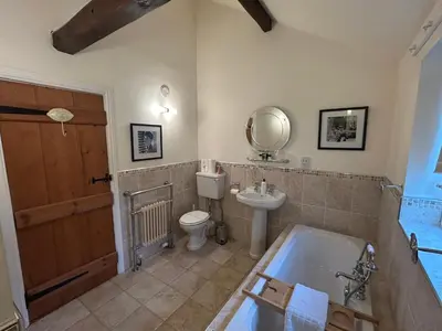 a bathroom with a tub and a toilet and a sink at Hollyside Lodge in Carlisle