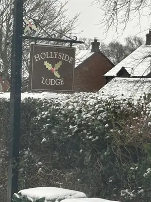 a sign for a hollyside lodge in the snow at Hollyside Lodge in Carlisle