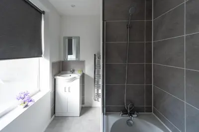 a bathroom with a shower and a sink at 5 Bed Workington House with Parking Near Station in Workington