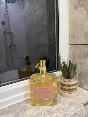 a bottle of soap sitting on a counter next to a window at Modern 4-Bed Family Home in Solihull in Moffat
