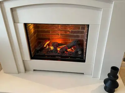 a fireplace in a living room with a fire at Modern 4-Bed Family Home in Solihull in Moffat