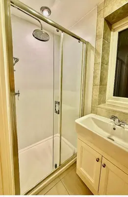 a bathroom with a shower and a sink at Modern 4-Bed Family Home in Solihull in Moffat