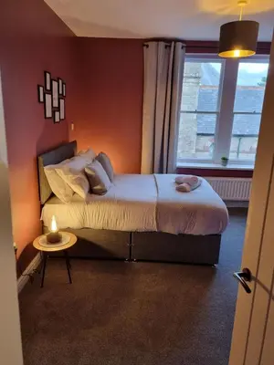 a bedroom with a large bed and a window at No3 Spacious Apartment Cockermouth in Cockermouth