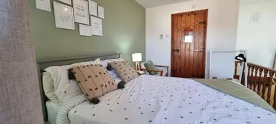 a bedroom with a large bed with pillows on it at The Creamery High Harrington in Harrington