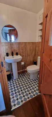 a bathroom with a sink and a toilet and a mirror at The Creamery High Harrington in Harrington