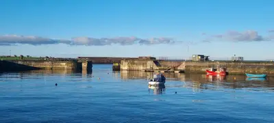 a small boat in a body of water at The Creamery High Harrington in Harrington