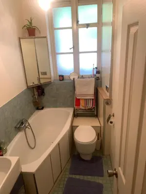a bathroom with a tub and a toilet and a window at Elegant, Cozy 1 Bedroom Flat In Heart Of London Pimlico in Moffat
