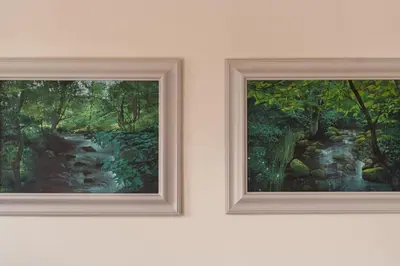 two paintings on a wall next to each other at Swallow Barn at Greenclose Farm in Penrith