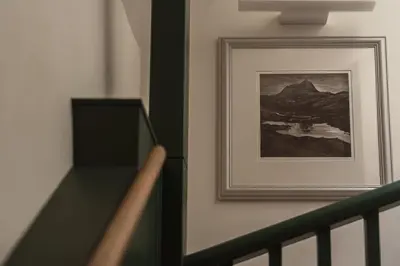 a picture on a wall next to a staircase with a picture at Swallow Barn at Greenclose Farm in Penrith