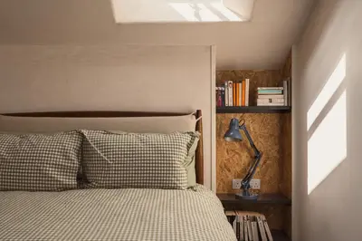 a bedroom with a bed and a book shelf at Swallow Barn at Greenclose Farm in Penrith