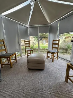 a tent with two chairs and a ottoman in a room at Honey House in Moffat