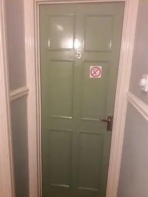 a green door with a no smoking sign on it at Studio No5, Cockermouth The Lakes in Cockermouth