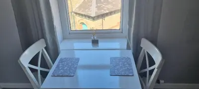 a white table with two chairs and a window at Studio No5, Cockermouth The Lakes in Cockermouth
