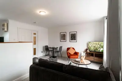 a living room with a couch and a table at Lovely 1 Bed Harbour-side Apartment - Sea Views in Whitehaven