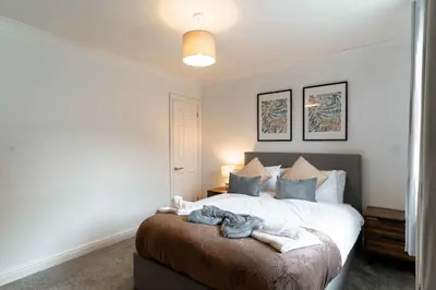 a bedroom with a bed with towels on it at Lovely 1 Bed Harbour-side Apartment - Sea Views in Whitehaven