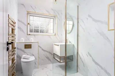 a white bathroom with a toilet and a window at No22 Shalloch House - Donnini Apartments in Ayr