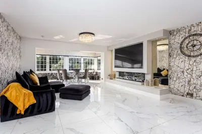 a living room with a fireplace and a tv at No22 Shalloch House - Donnini Apartments in Ayr