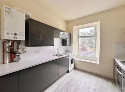 a kitchen with a sink and a dishwasher at Central Charming Sea View Loft Flat in Troon