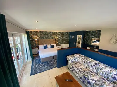a hotel room with a bed and a couch at The Little Inn at Grasmere in Grasmere