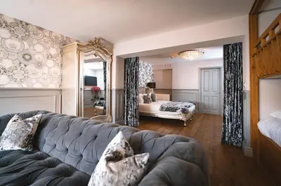 a living room with a couch and a bedroom at The Little Inn at Grasmere in Grasmere