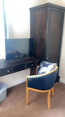 a blue chair sitting in front of a tv at QueensBerry Annan in Annan
