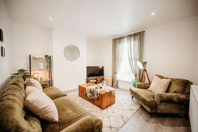 a living room with a couch and a table at 4 Bed Sheffield home in Moffat