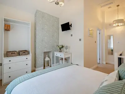 a bedroom with a bed and a tv on a wall at 1 Bed in Keswick 96314 in Keswick