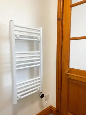 a white refrigerator in a room next to a door at Borders Retreat, Cosy 1 Bed Flat - 3miles from M6 Jct45 - near A75, Gretna & Carlisle in Longtown