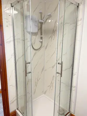 a shower with a glass enclosure in a bathroom at Borders Retreat, Cosy 1 Bed Flat - 3miles from M6 Jct45 - near A75, Gretna & Carlisle in Longtown