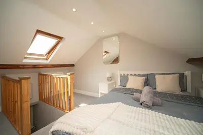 a bedroom with a large bed and a skylight at Spacious 3 Bedroom home in Ascot, Sleeps 5, Parking in Moffat