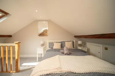 a bedroom with a large bed in a attic at Spacious 3 Bedroom home in Ascot, Sleeps 5, Parking in Moffat