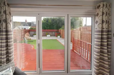 a sliding glass door with a view of a patio at Seabreeze in Prestwick in Prestwick