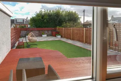 a view of a yard from a window of a patio at Seabreeze in Prestwick in Prestwick