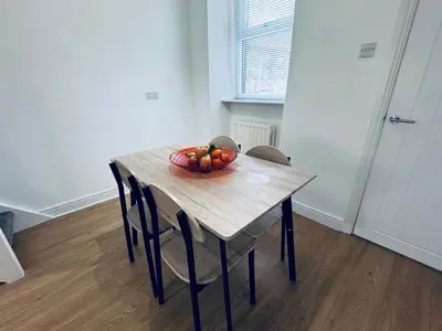 a wooden table with a bowl of fruit on it at Holly Terrace - 2 Bedrooms - Sleeps 3 in Whitehaven