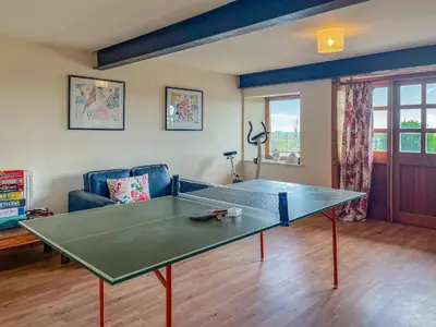 a ping pong table in a living room at Townhead Mill in Dumfries